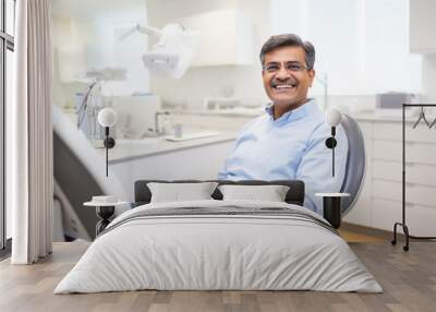 A man sitting in a dentist's office and smiling. Wall mural