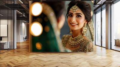 Beautiful indian bride doing make up in front of mirror Wall mural