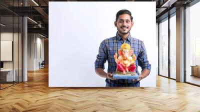 Celebrate ganesha festival.young indian handsome man with lord ganesha. Wall mural