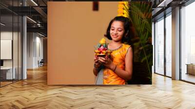 Cute Indian little girl holding diya or oil lamps for Diwali Celebration. Wall mural