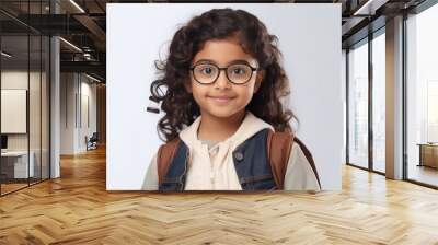 Cute indian little school girl wearing eyeglasses Wall mural