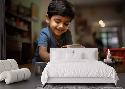 Cute little in boy playing with toy at room Wall mural