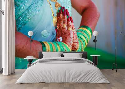 Hands of bride is decorated beautifully by indian mehndi art along with jewelery’s and colorful bangles Wall mural