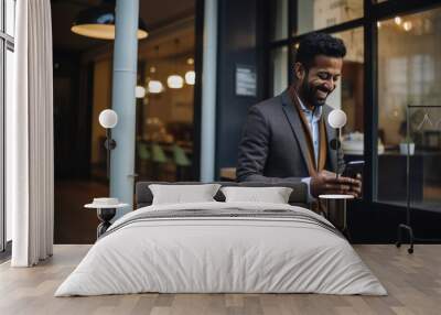 Indian businessman using smartphone at restaurant Wall mural