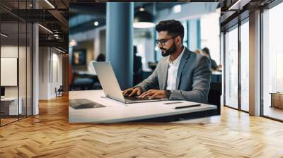 Indian businessman working on laptop at office. Wall mural