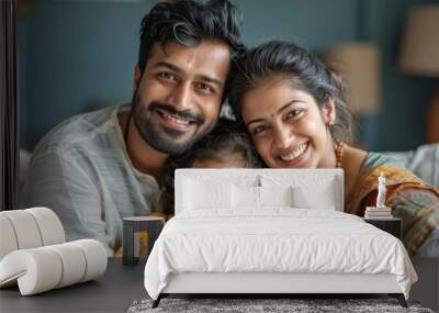 Indian couple giving happy expression with his baby girl child Wall mural