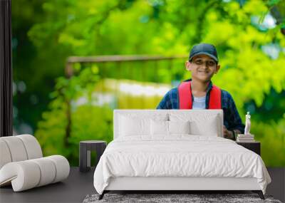 Indian cute schoolboy with backpack, Back to school concept Wall mural