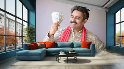 Indian farmer showing money and giving happy expression. Wall mural