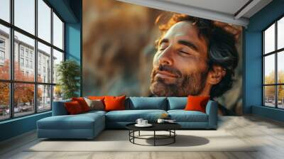 Man with closed eyes enjoying a moment of calm and relaxation. Wall mural