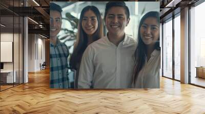 mexican coworkers standing together in the office smiling. Wall mural