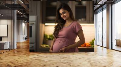 pregnant woman standing at kitchen and cooking healthy food for herself. Wall mural