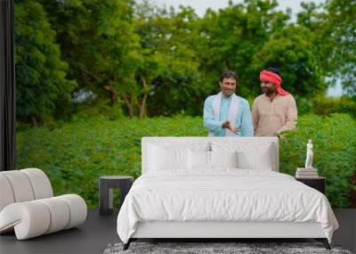 Two indian farmers talking at cotton agriculture field. Wall mural