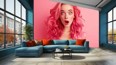 Young beautiful woman giving shocking expression on pink background Wall mural