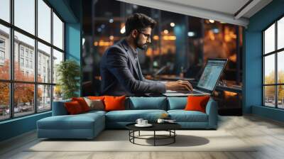 Young businessman or corporate employee using laptop at office. Wall mural