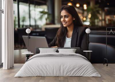 Young indian businesswoman or corporate employee using laptop Wall mural