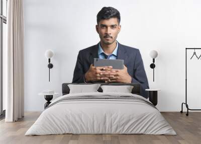 Young indian man in suit and giving expression on white background Wall mural