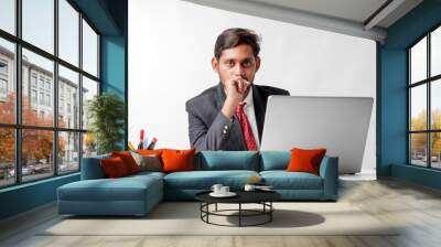 Young indian man in suit and working on laptop at office Wall mural