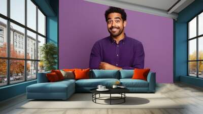 young indian man standing on violet color background Wall mural