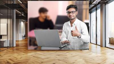 young indian man working at office Wall mural