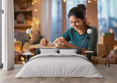 young indian woman is packaging products in cardboard boxes Wall mural