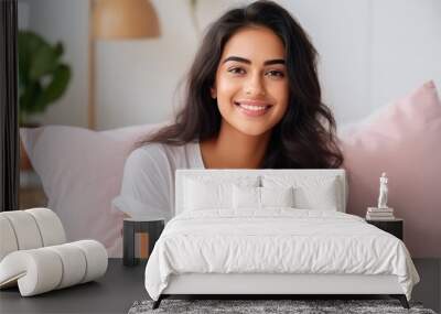 young indian woman relaxing on bed at home Wall mural