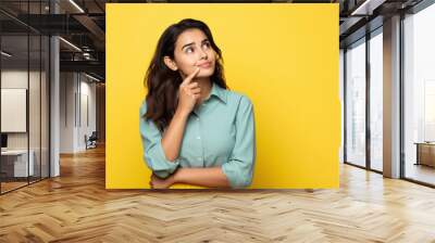 young indian woman thinking on isolated background Wall mural