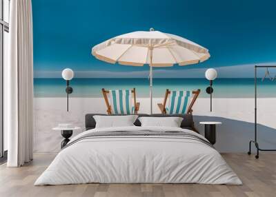 Beach chairs and an umbrella on a white sand beach. Wall mural