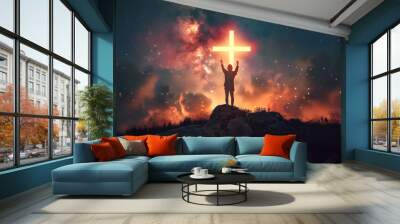 Christian cross symbol in the night sky with silhouette of person with their arms raised worshipping God Wall mural