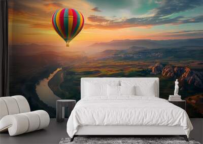 Colorful hot air balloon flying over green valley with road and mountain background at sunrise, bucket list lifestyle concept Wall mural