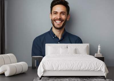 Handsome smiling business man in blue shirt isolated on gray background Wall mural