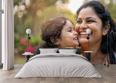 Happy indian mother having fun with her daughter outdoor - Family people and love concept - Focus on mum face AI Wall mural