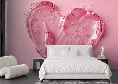 Liquid gel cosmetic smudge texture in heart shape on pink background. Aesthetic beautiful textured smear transparent skin gel or face mask like heart. Top view or flat lay Wall mural