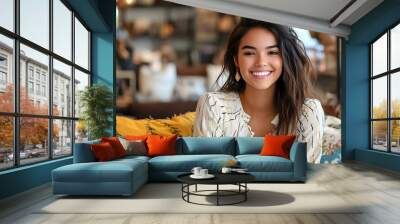 Portrait of a beautiful young entrepreneur smiling while sitting on a comfy couch in her home decor store Wall mural