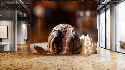 product photo of molten chocolate lava cake, half split by spoon, restaurant background. poster, card Wall mural