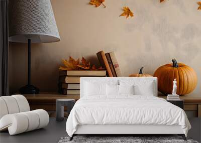 Pumpkins with autumn leaves, books and lamp on commode in living room Wall mural