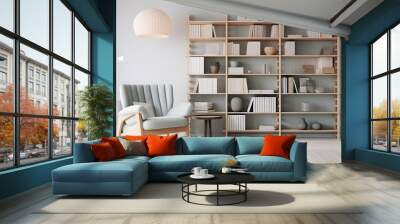 scandinavian bookcase with armchair in modern cozy interior of room. Home library with book shelf. Wall mural