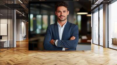 Smiling confident young businessman looking at camera standing in office. Elegant stylish corporate leader successful ceo executive manager. Wall mural