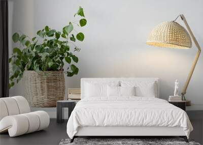 Table with books, cup of tea, houseplant and desk lamp near white wall Wall mural