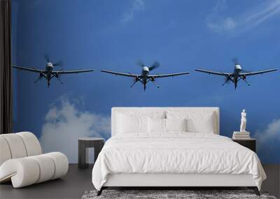 Three military drones flying in the blue sky Wall mural