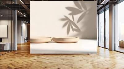 Two minimal modern wooden round tray podium on white glossy table counter in sunlight, leaf shadow on beige wall background for luxury beauty, organic, health, cosmetic, fashion product display Wall mural