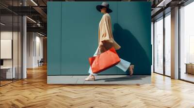 Unrecognisable stylish woman walking with shopping bags. Wall mural