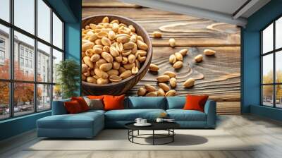 Fisheye Pealed Peanuts in a black bowl isolated on wooden background Wall mural