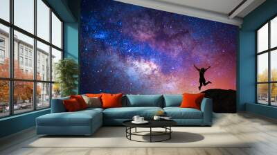 milky way, star, with happy girl jumping on the mountain Wall mural