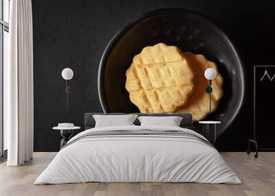 Carrom seed cookies or salted ajwain cookies are placed in a black bowl on a black background. Wall mural