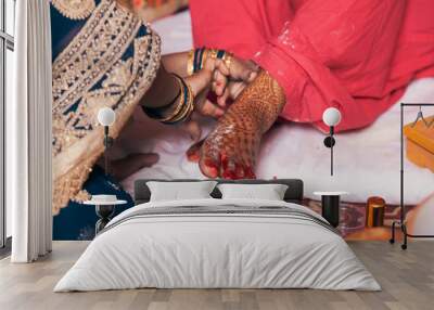 Indian bride in a Feet Coloring Ceremony during a Hindu wedding ritual. Wall mural