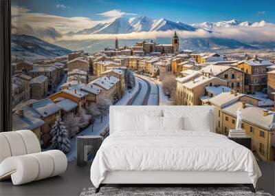 Snow covered street and Gran Sasso d'Abruzzo in winter from above with drone Worm's Eye View Wall mural