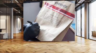 hand in glove writing on evidence bag and seal by red tape  Wall mural