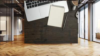 Above view of blank notepad, laptop, glasses and coffee cup and wooden working desk Wall mural