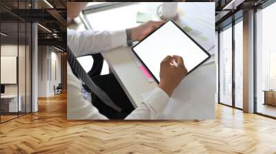 Businessman working with mockup tablet and digital pen on empty monitor tablet. Wall mural