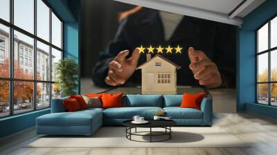 Businesswoman showing 5 stars rating with home model. Real estate appraisal concept and excellent service concept Wall mural